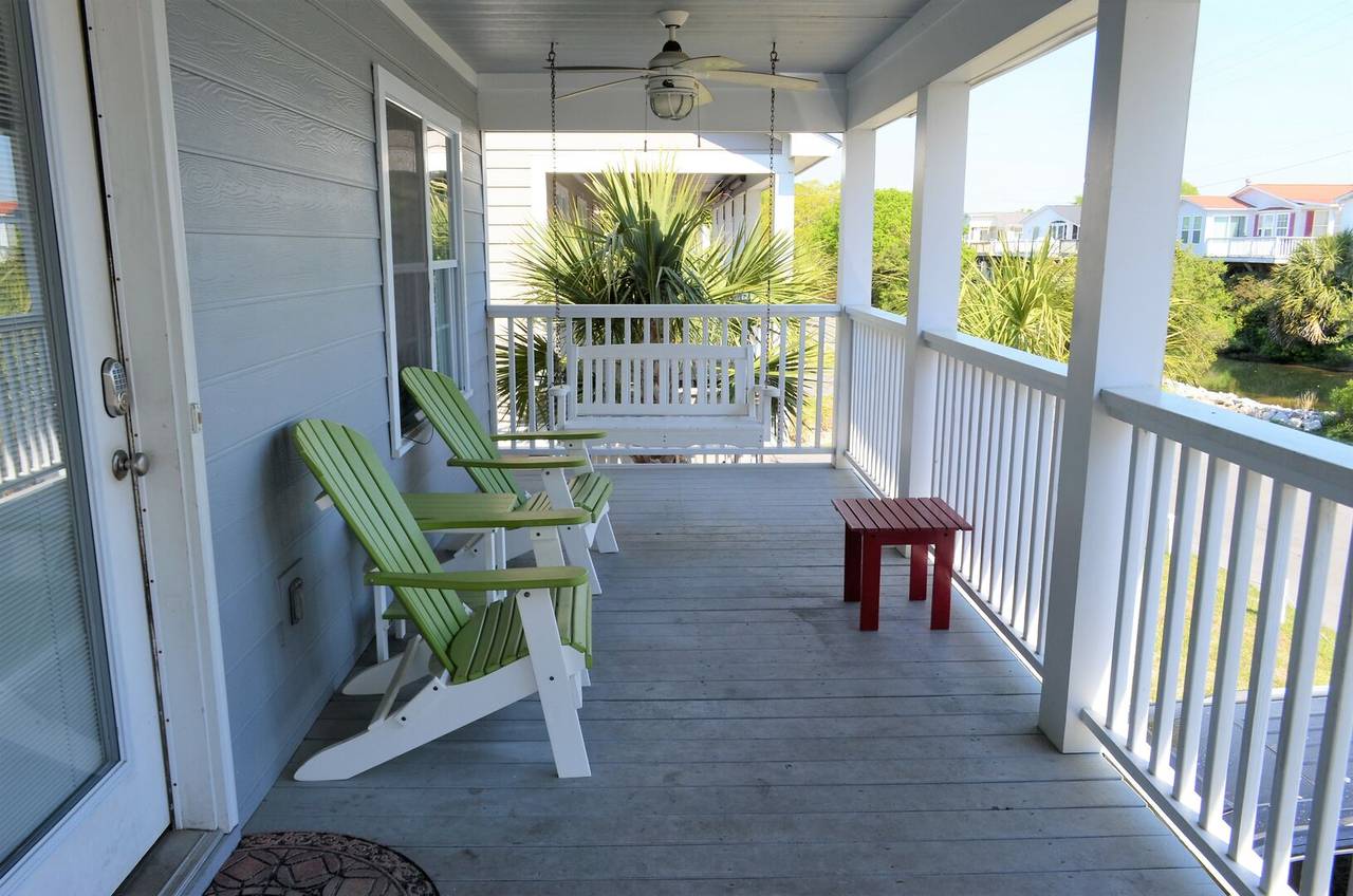 Spacious covered porch with a swing Spacious covered porch with a swing