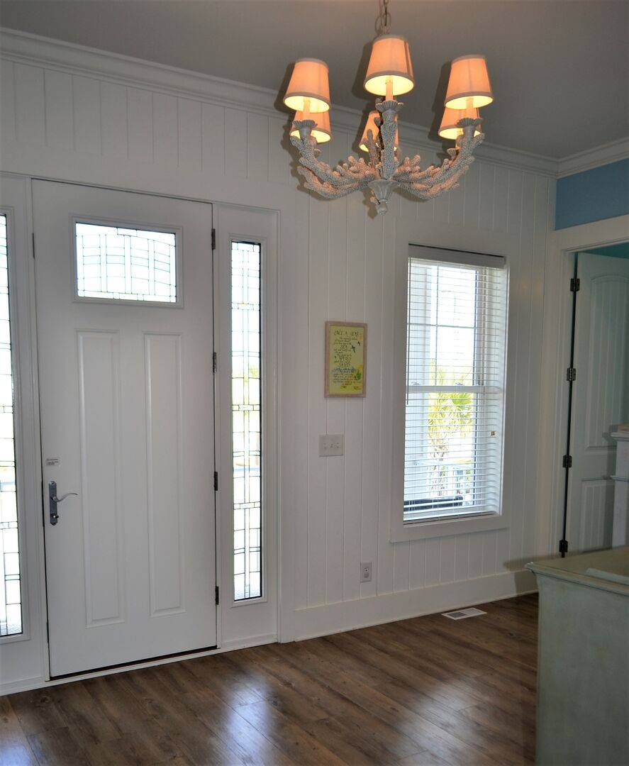 Street Side door leads to a covered porch with marsh views. Street Side door leads to a covered porch with marsh views.