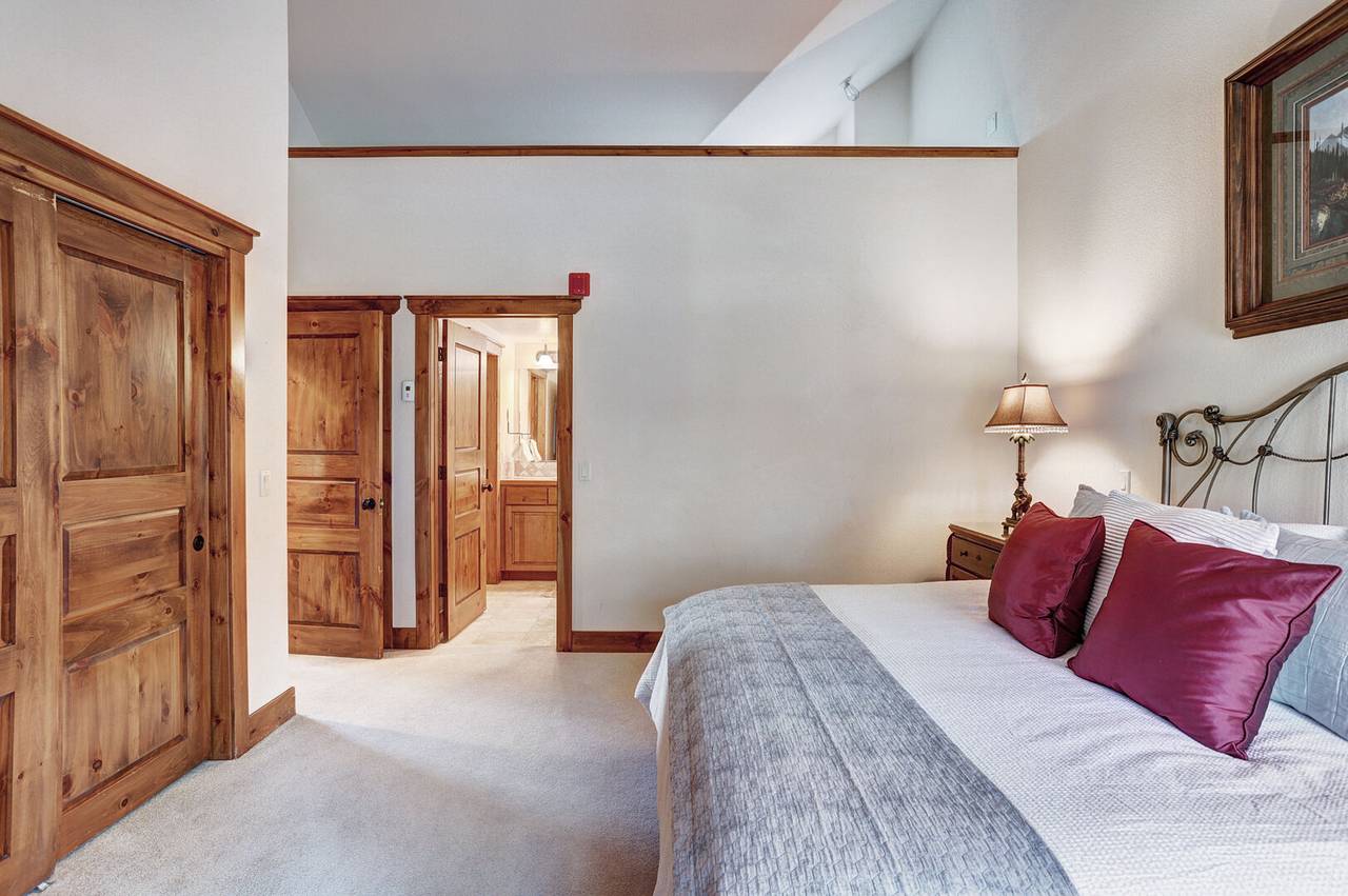 This primary bedroom offers ample closet space and a private ensuite bathroom - Amber Sky Breckenridge Vacation Rental This primary bedroom offers ample closet space and a private ensuite bathroom - Amber Sky Breckenridge Vacation Rental
