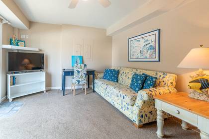 Media room with flat screen TV and desk for remote work convenience.