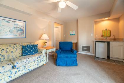 Media room with flat screen TV and desk for remote work convenience.