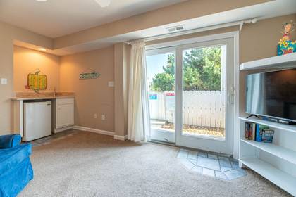 Media room with flat screen TV and desk for remote work convenience.