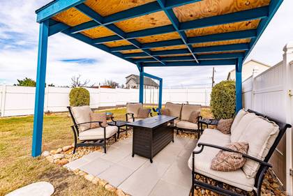 covered seating area with firepit table!